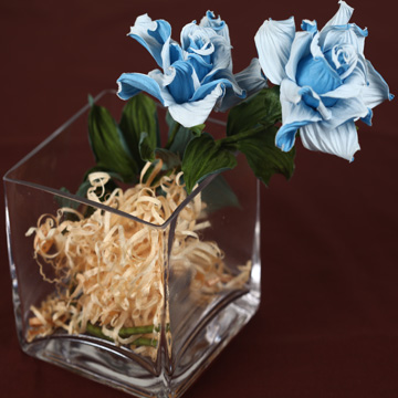 On stereometric formula clear glass table potted flower: Pretty rose